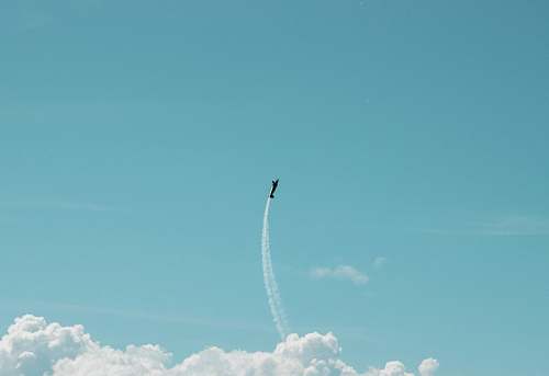 transportation plane flying with contrail during daytime vehicle