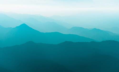 mountain silhouette of mountain at daytime teal