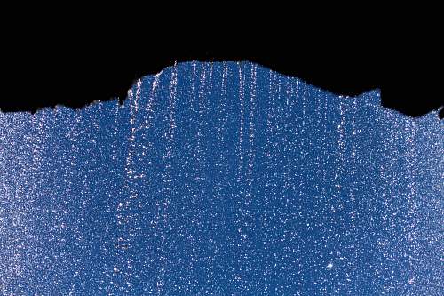 water silhouette of rock formation with rain droplets henrhyd waterfall