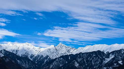 mountain snow covered mountain under cloudy sky at daytime snow