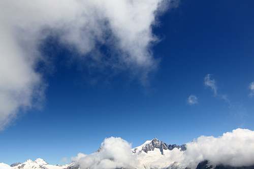 sky snow covering mountain under blue sky cloud