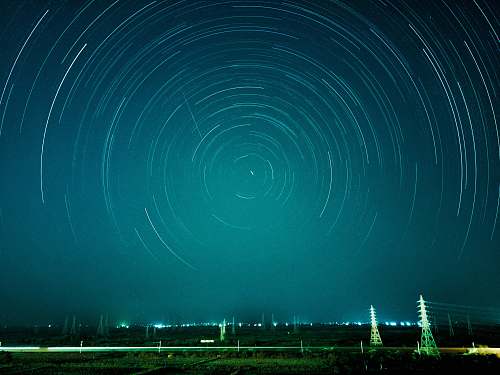 teal time-lapse photograph of stars night