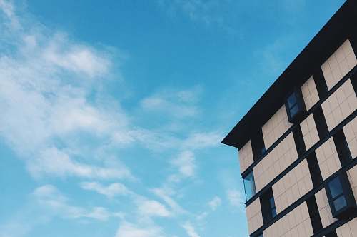 building top view angle of white high-rise building under blue sky housing