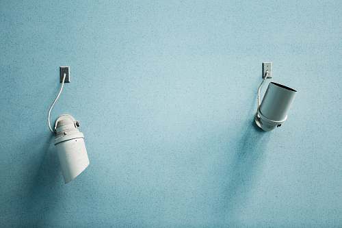minimalism two surveillance cameras on wall spotlight
