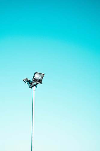 minimal white and black light post under blue sky blue sky