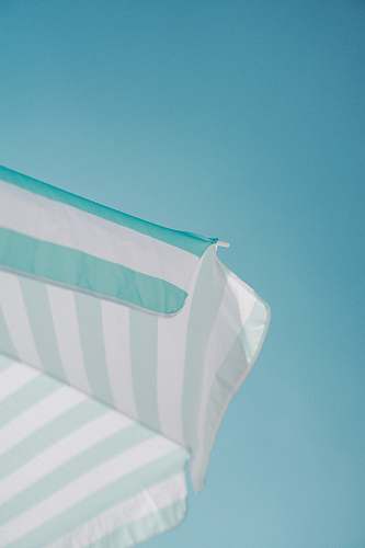 teal white and green striped parasol during daytime photo summer