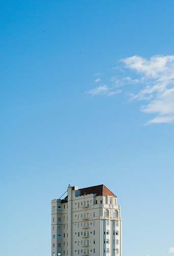 building white concrete building under blue sky apartment building