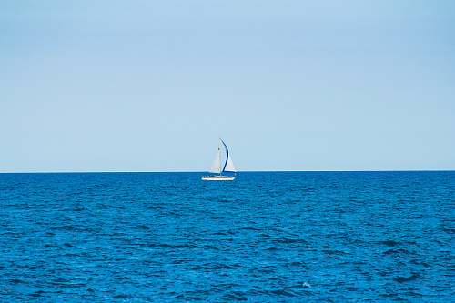 boat white sailboat in the middle of the ocean during day transportation