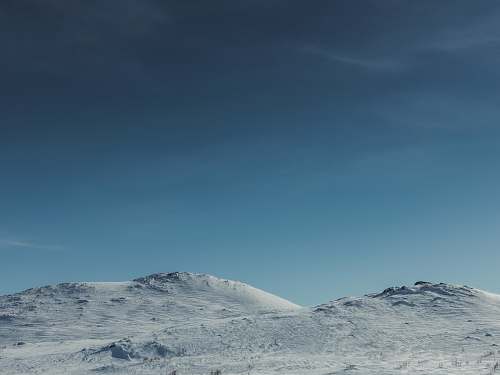mountain white snowy land under blue sky snow