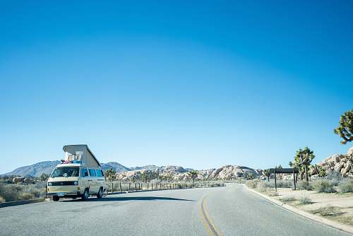van white van on road during daytime vehicle