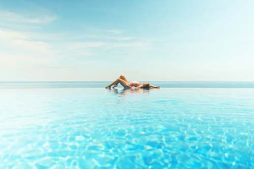 ocean woman sun bathing on beach water