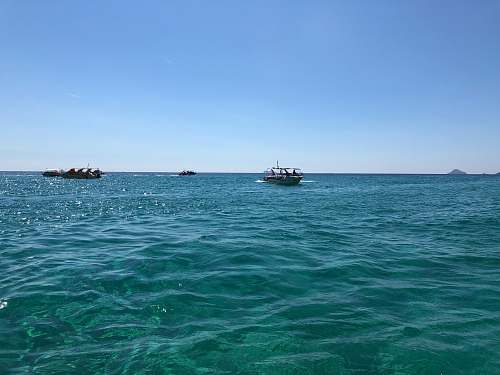 transportation powerboat on body of water under blue sky vehicle
