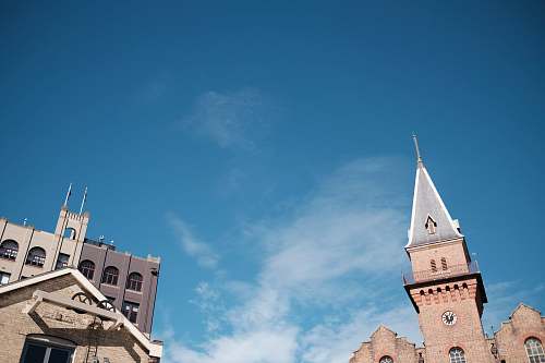 architecture brown castle under blue and white skies tower