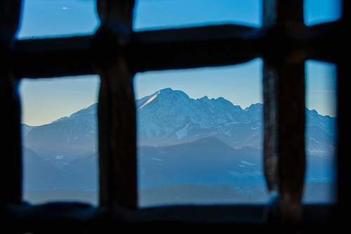 blue photography of mountain range during daytime window