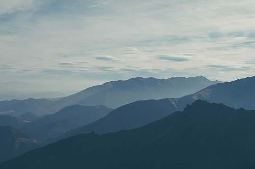grey silhouette of mountains covered with fog mountain range