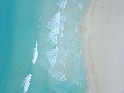 outdoors bird's-eye view photo of sea waves crashing on shore ice