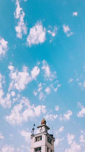 outdoors gray concrete tower during daytime azure sky
