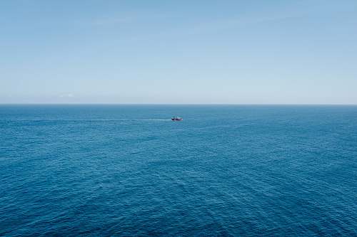 ocean photography of traveling ship during daytime sea