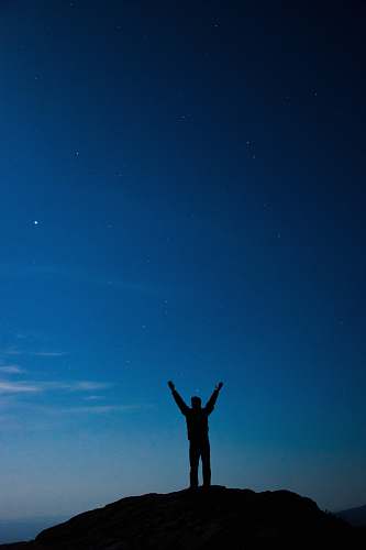 outdoors silhouette of man standing on hill with arms wide open human
