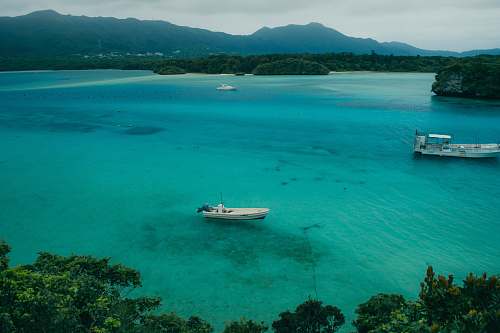 outdoors white boat on body of water during daytime land