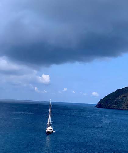 land white boat under grey clouds outdoors