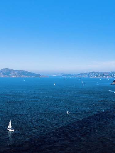 outdoors white sailboat on body of water during daytime ocean