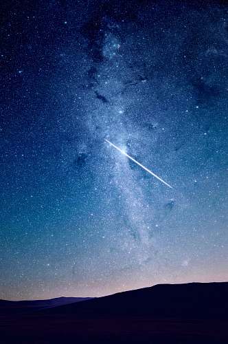 space shooting star under blue sky stars