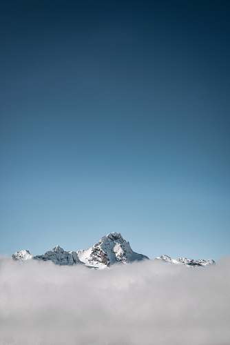 mountain selective focus photography of white mountain under blue calm sky alps