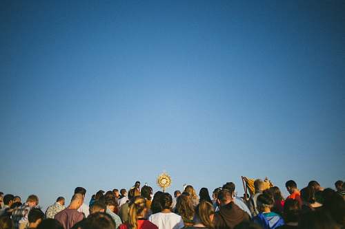 blue standing people during daytime crowd