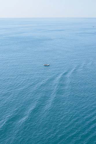 ocean boat on calm body of water water