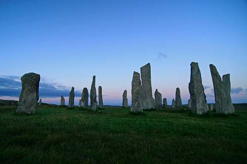 outdoors lined rocks on green grass field landmark rock