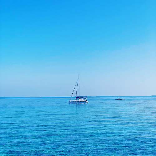 transportation white and blue boat on body of water at daytime boat