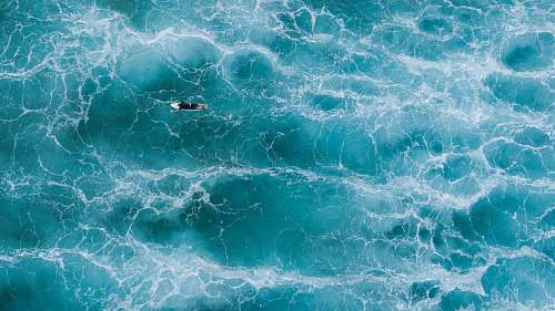 nature aerial photography of surfer on body of water ocean