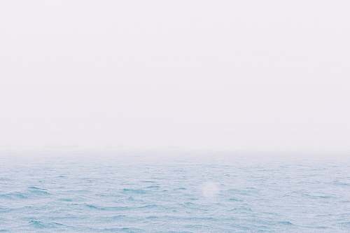 blue body of water during daytime photo sky