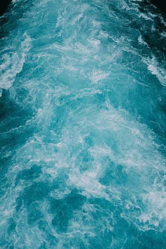 blue time lapse photography of waves of water teal