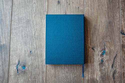 blue blue book on brown wooden board hardwood