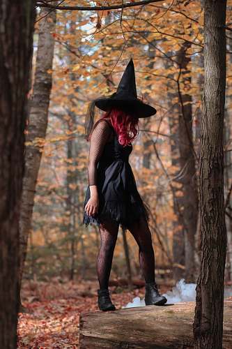 clothing witch standing under trees person
