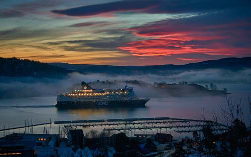 vehicle white cruise ship on body of water during dusk transportation