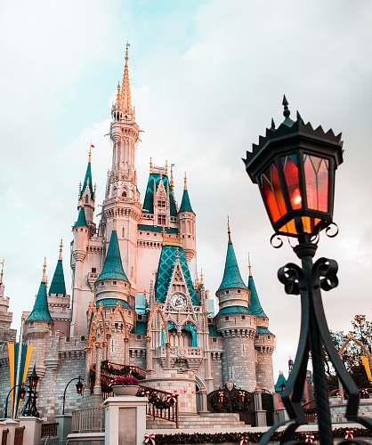 architecture white and blue castle under cloudy sky during daytime castle