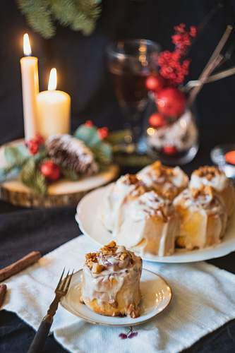 fork cinnamon roll on a ceramic saucer cutlery
