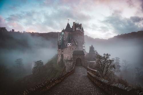 building closeup photo of castle with mist architecture