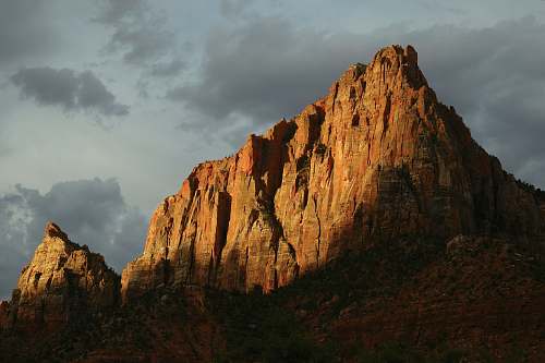 mountain brown mountain under gray sky peak