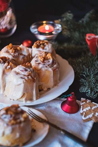 candle plate of cinnamon rolls beside a lighted tealight dessert