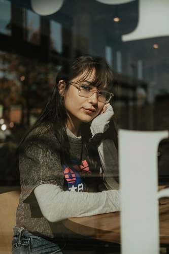 accessories woman leaning on brown table inside the restaurant accessory