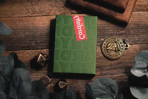 text green Cardistry box on brown wooden surface wristwatch
