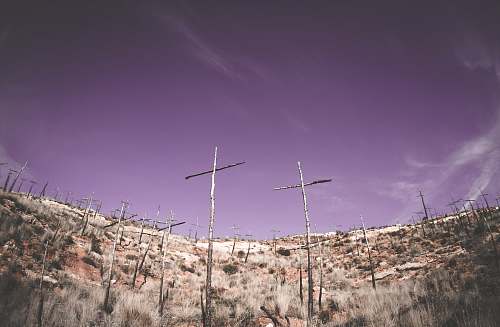 antenna low-angle photography gray wooden cross on hilltop electrical device
