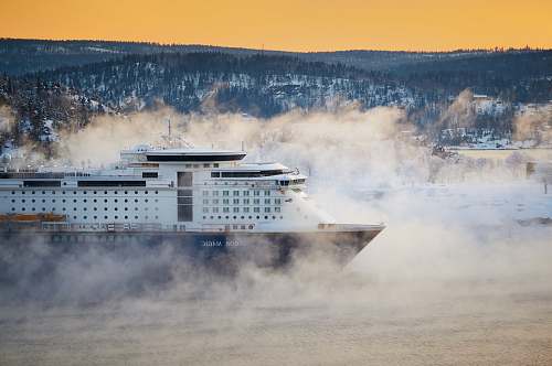 ship white and bleu cruise ship near mountain at daytime norway