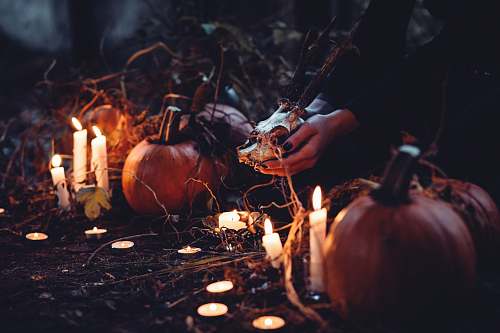 candle person decorating pumpkin and candles witch