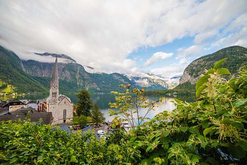 austria church beside body of water during daytime landscape