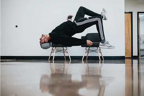 person man sitting on chair near wall los angeles